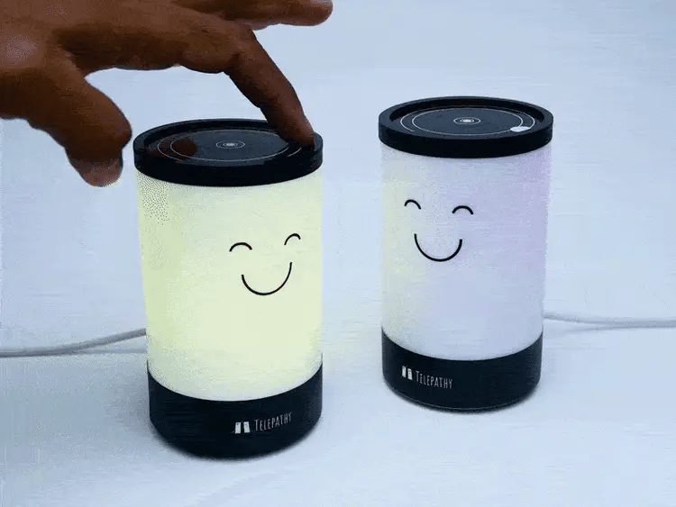 Two smart lamps glowing with soft blue light